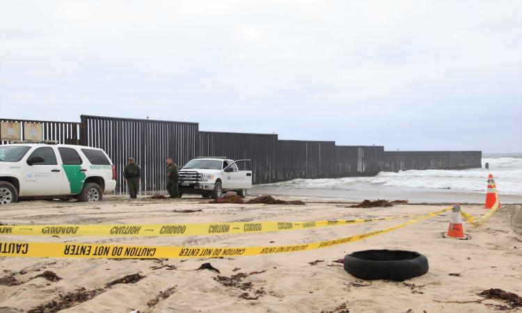 American policemen guard near the border wall between the U.S. and Mexico, in San Diego, the United States