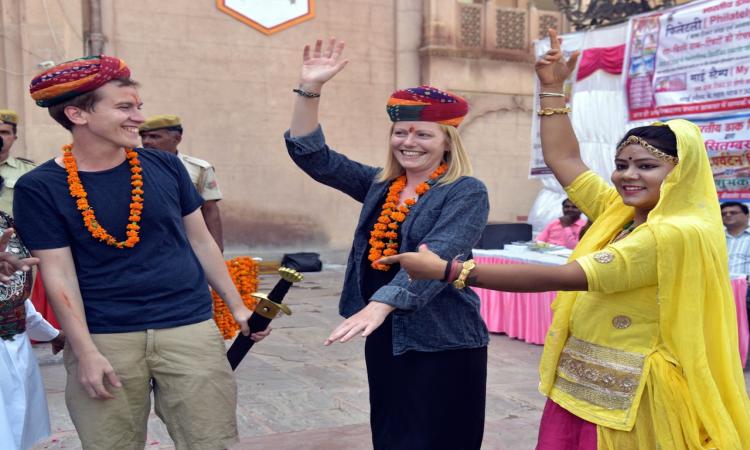 Foreign tourists enjoy with a folk artiste at Junagarh Fort