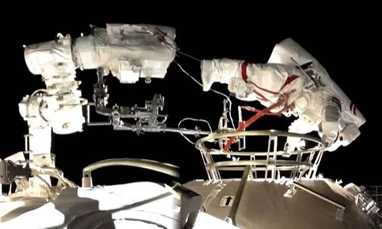 Chinese astronauts conduct first spacewalk outside new space station