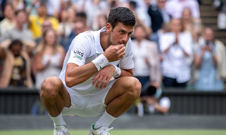 Wimbledon-Djokovic-celebrates-triumph-by-eating-grass-again