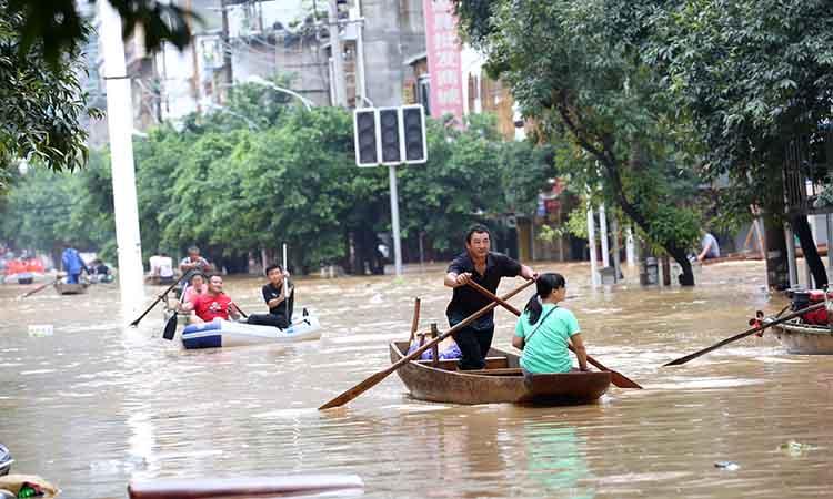 People-row-boats-flood-water