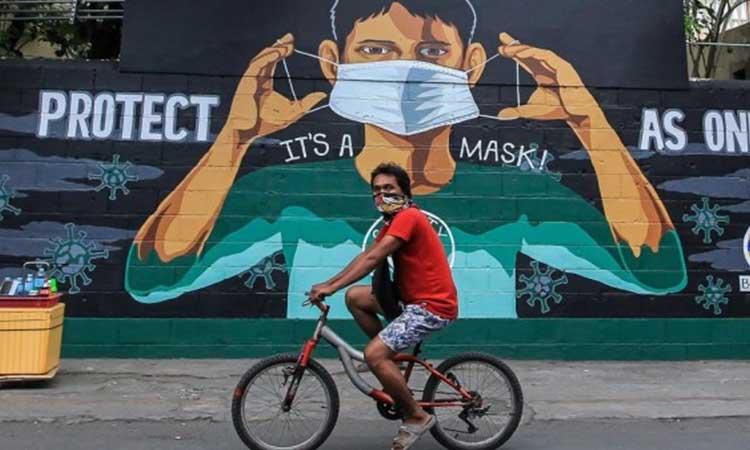 Man-wearing-mask-riding-bicycle