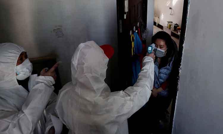 Health-worker-measuring-temperature-person