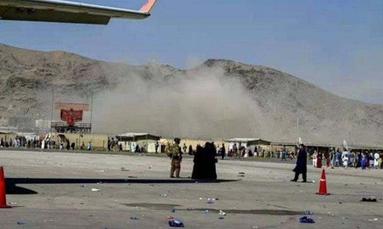 Smoke rises near the blast site at an airport in Kabul,