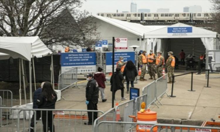 People-line-up-to-enter-a-mass-COVID-19-vaccination-site