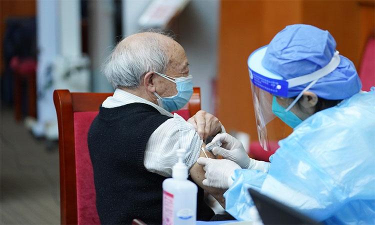 A-medical-worker-injects-COVID-19-vaccine-for-a-senior-citizen-in-Dongcheng-District-of-Beijing