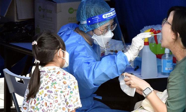 A-citizen-takes-COVID-19-nucleic-acid-test-at-a-mobile-nucleic-acid-testing-site-in-Hong-Kong