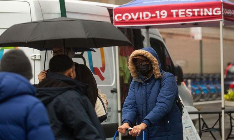 People-walk-past-a-COVID-19-testing-site-in-New-York-the-United-States