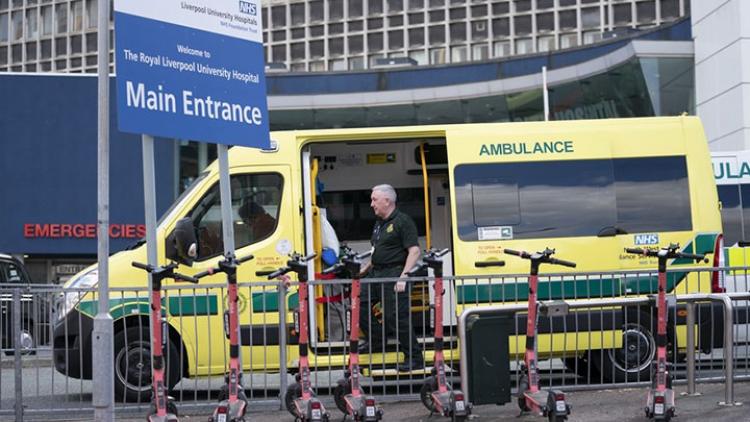 A-staff-member-stands-next-to-an-ambulance-outside-the-Royal-Liverpool-University-Hospital-in-Liverpool