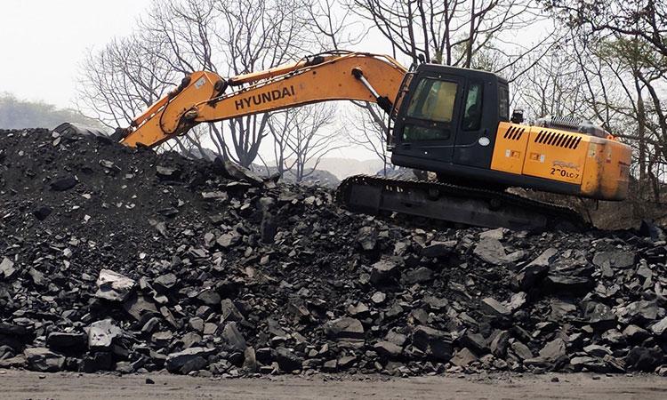A-bulldozer-removes-coals-from-a-coal-mine-in-Singrauli