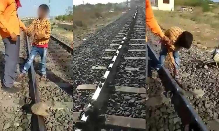 Minor-boy- placing-stones-on-railway-tracks