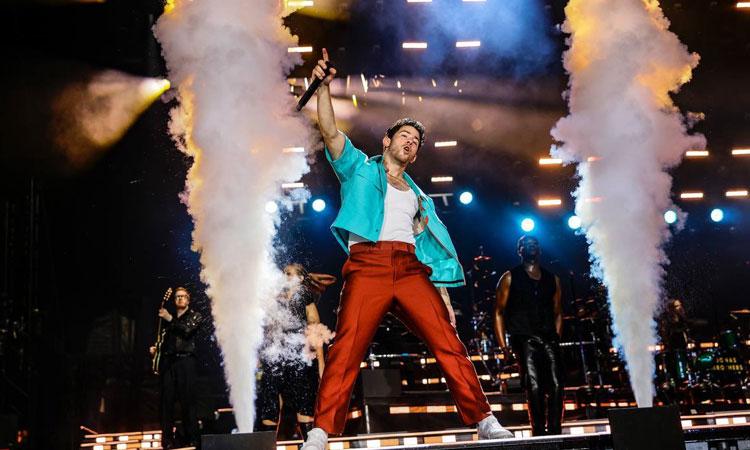 Nick-Jonas-falls-through-hole-on-stage-while-performing